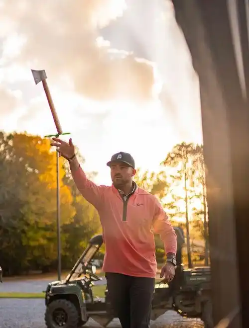 a man throwing an ax