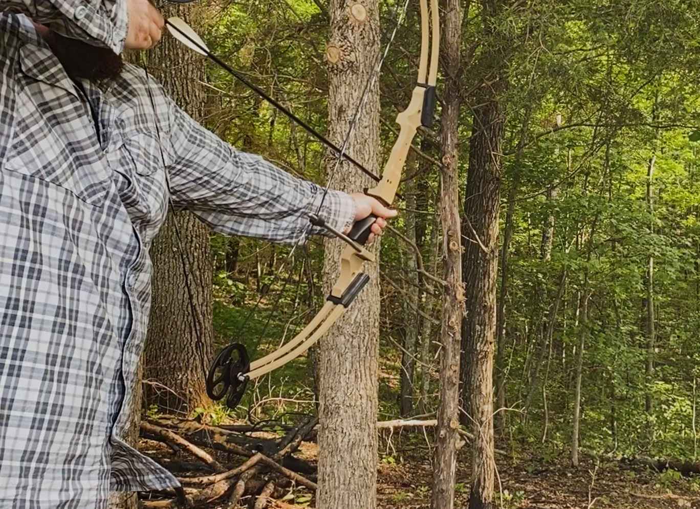 an adult practicing archery outside