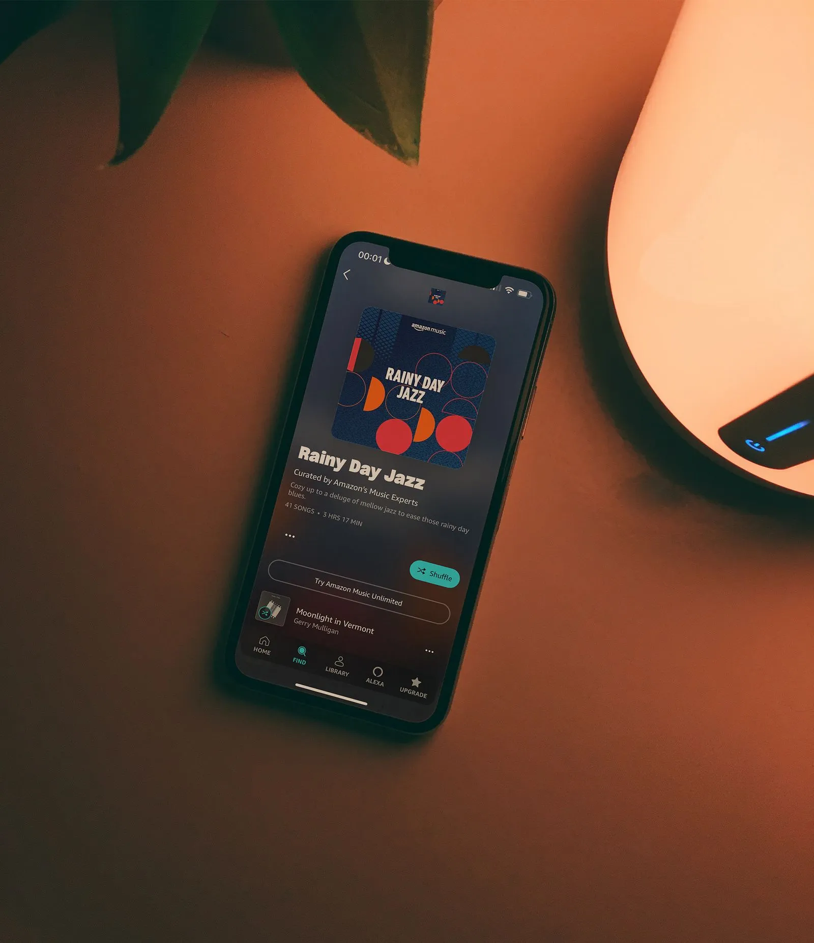 A phone on the table showing Rainbow Jazz on Amazon Music app