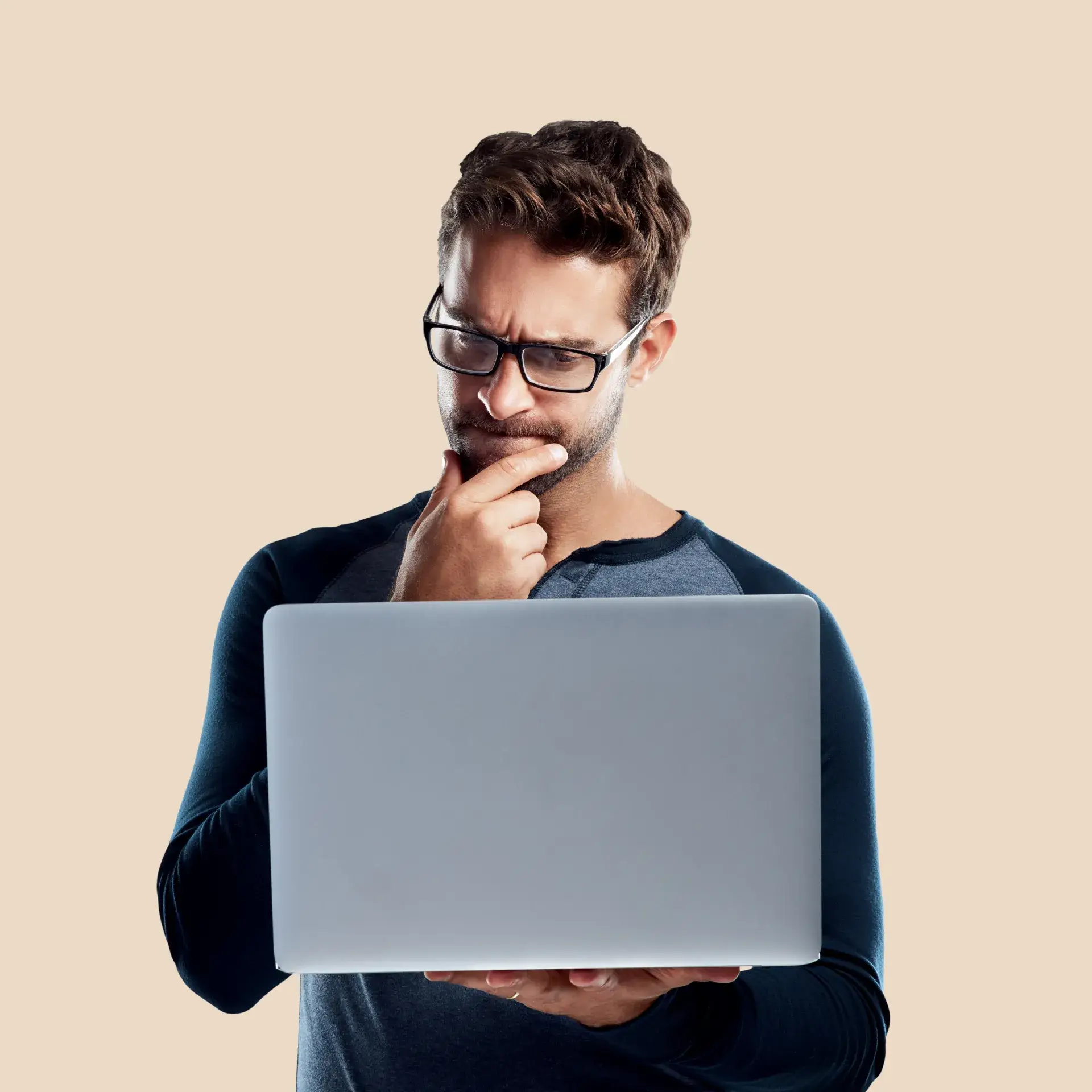 a man wearing glasses is looking at a laptop