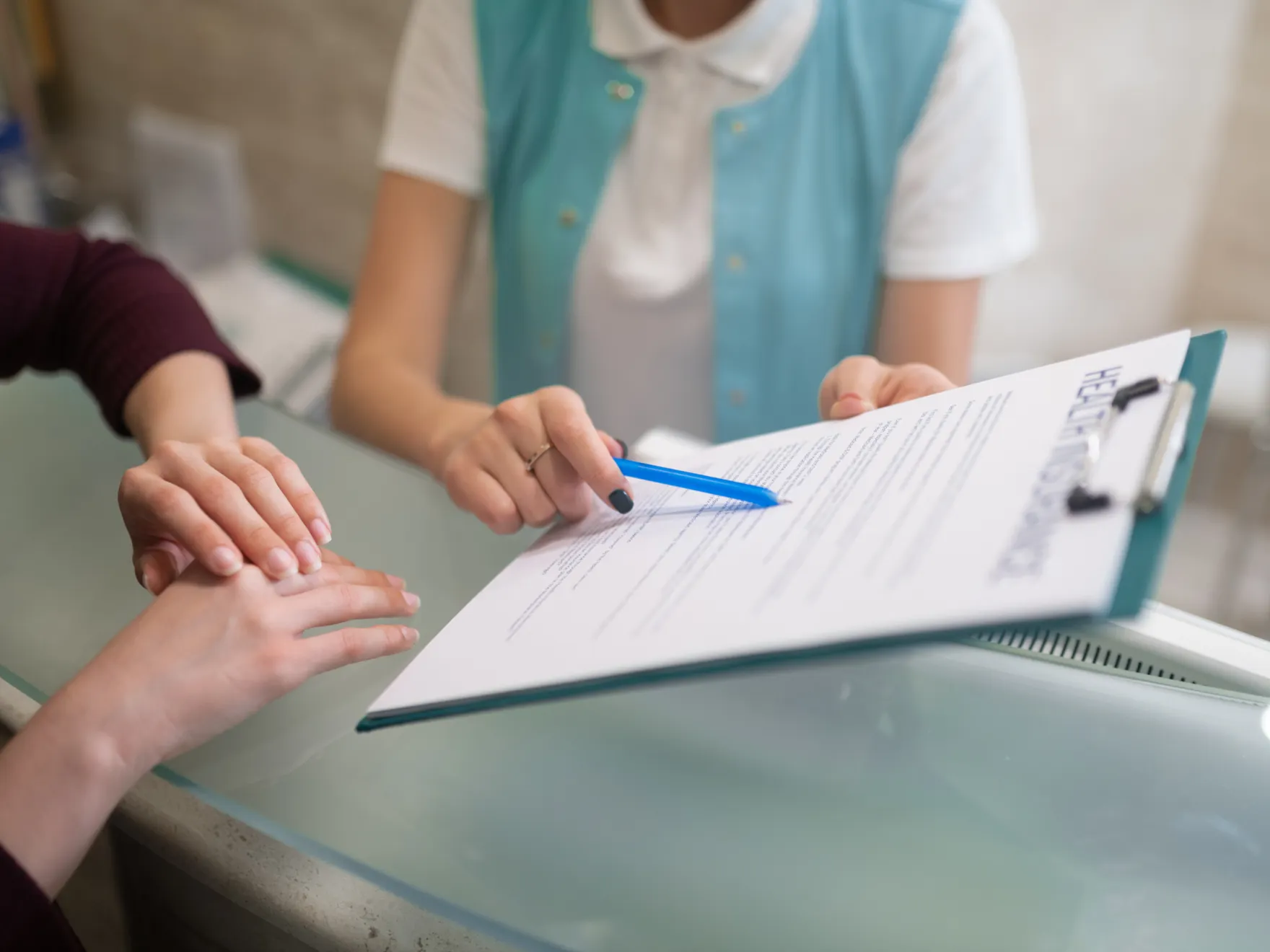 two people sitting at a table with a piece of paper