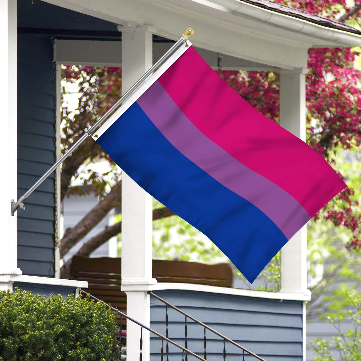 bisexual pride flag flying in front of a house