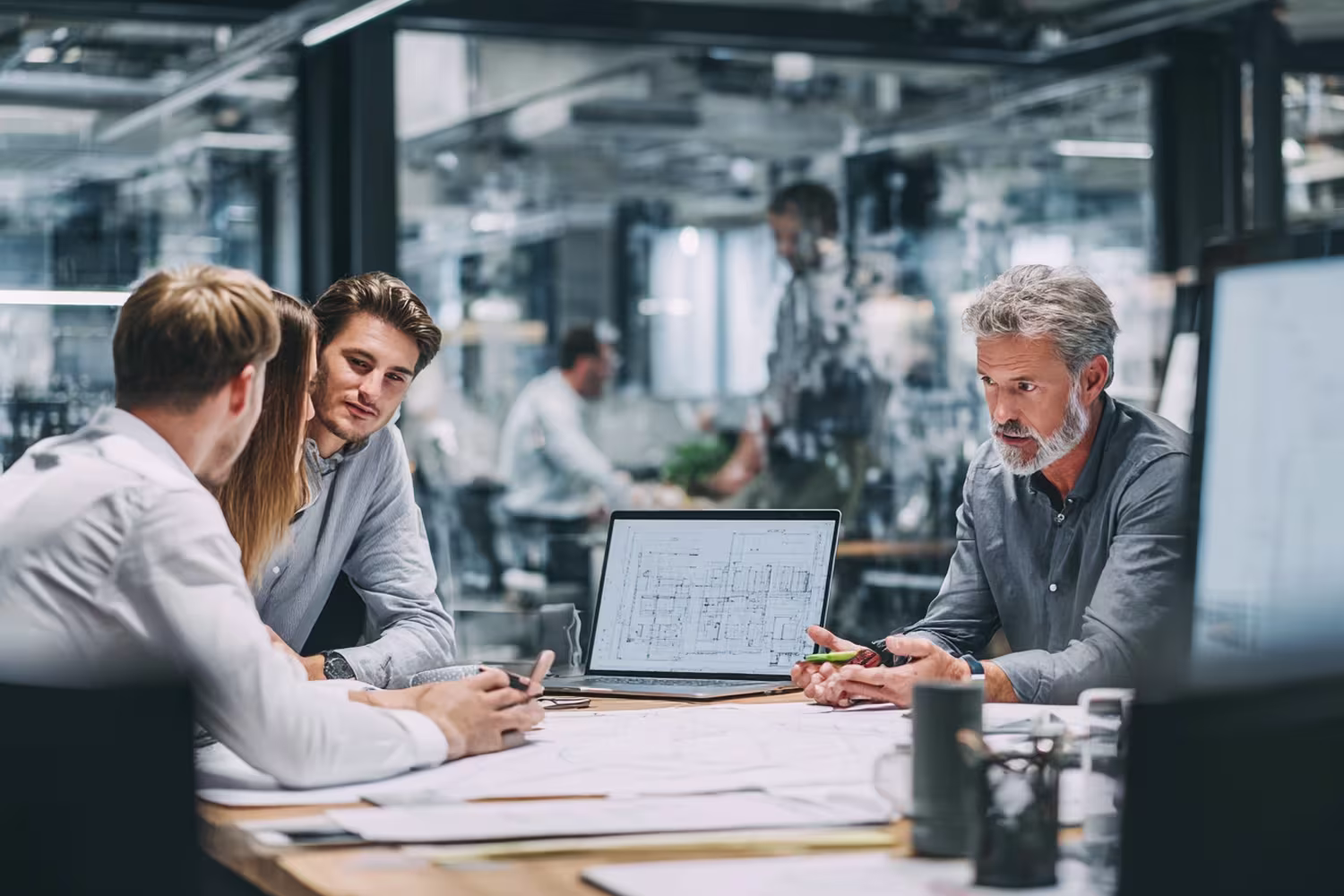 Diverse team using unified communications in modern office