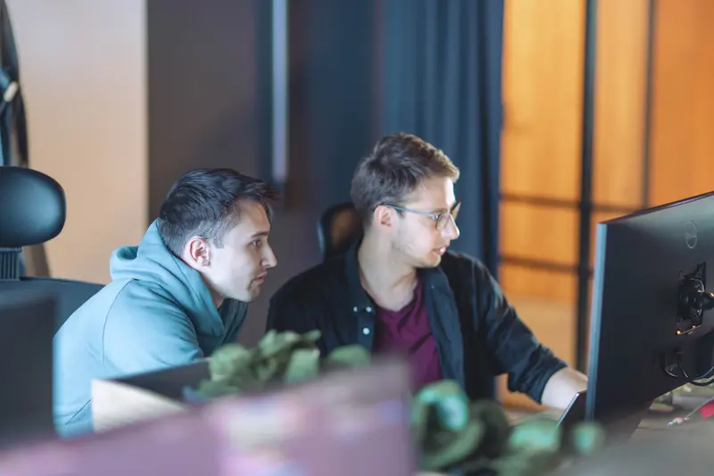 Group of software developers working on code at their desks.