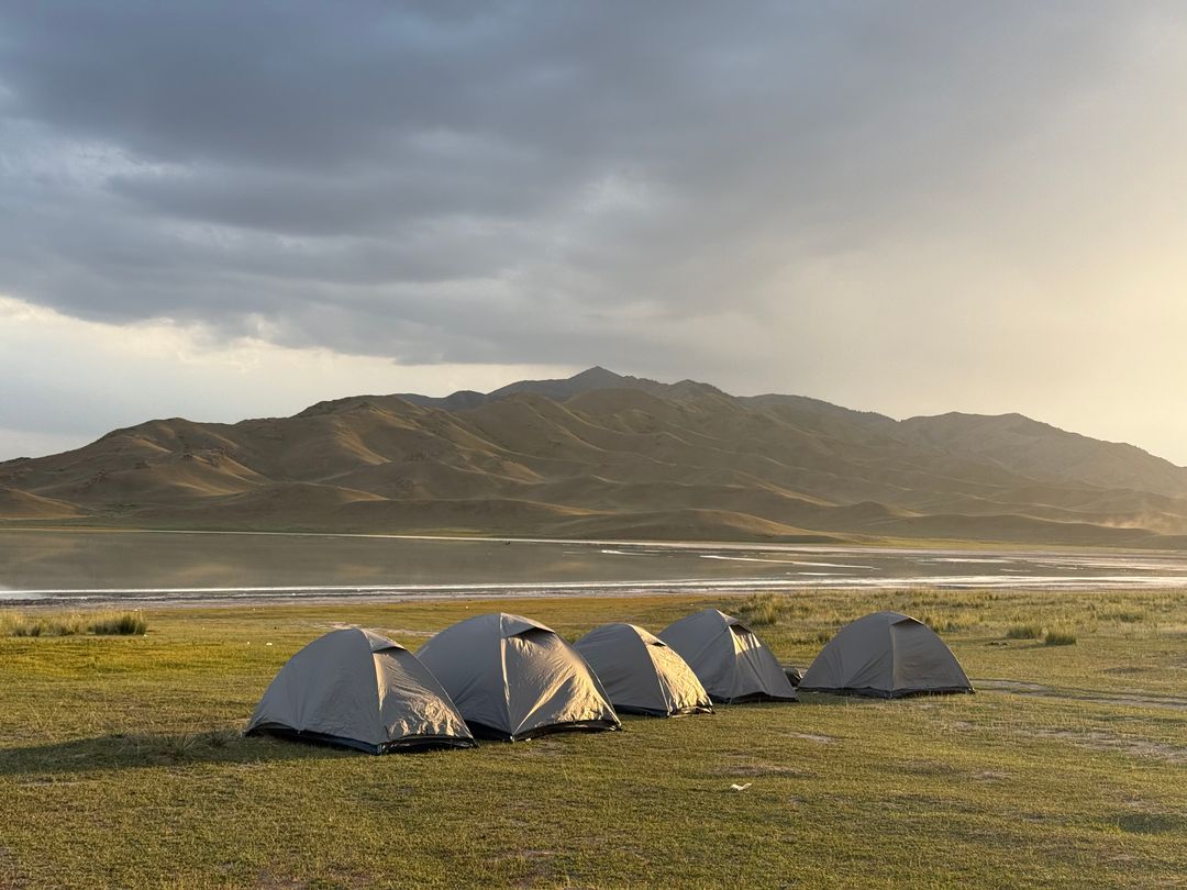 Tents pitched on the shore of Lake Tuzkol at sunset