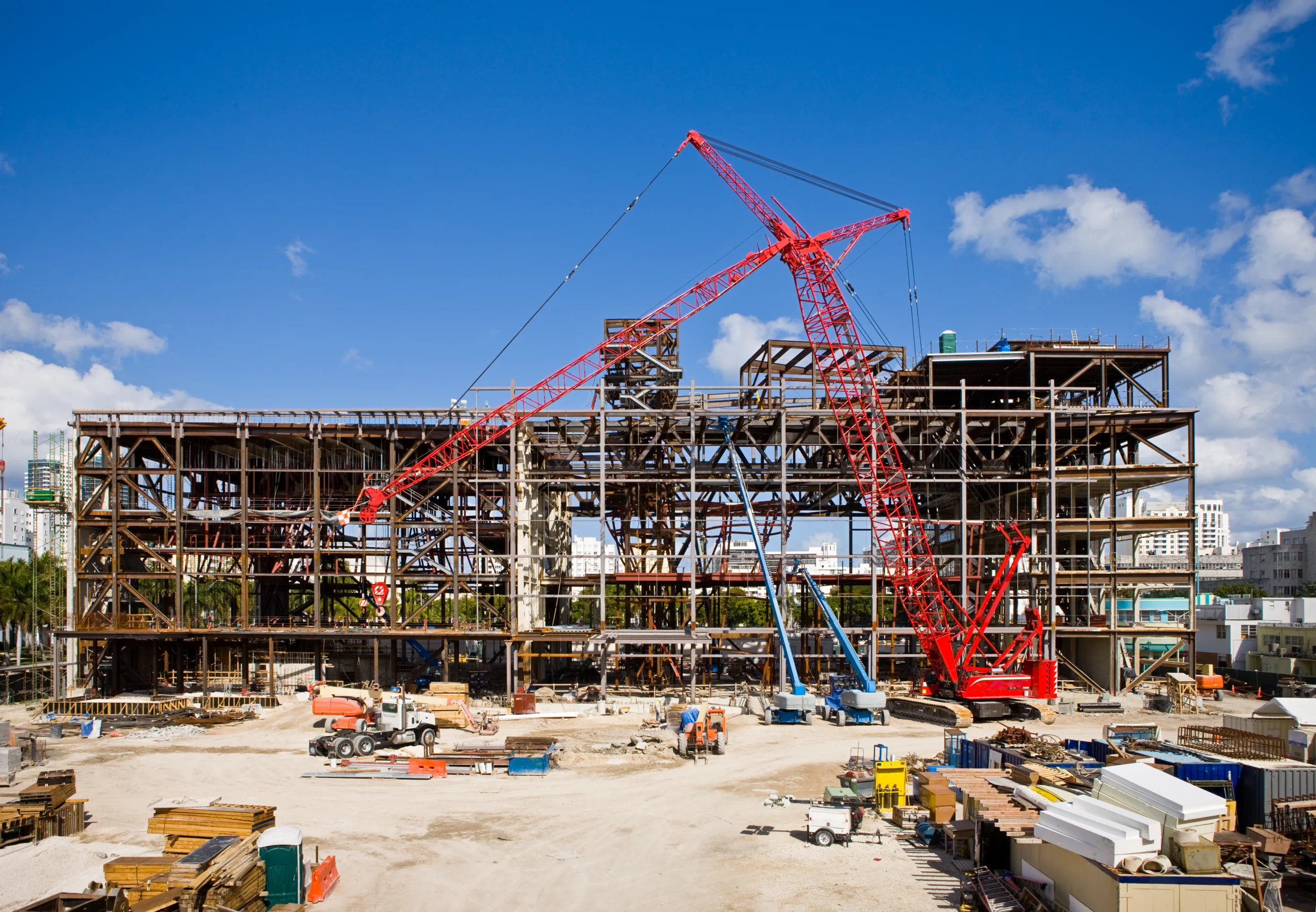Active construction site with cranes and steel framing