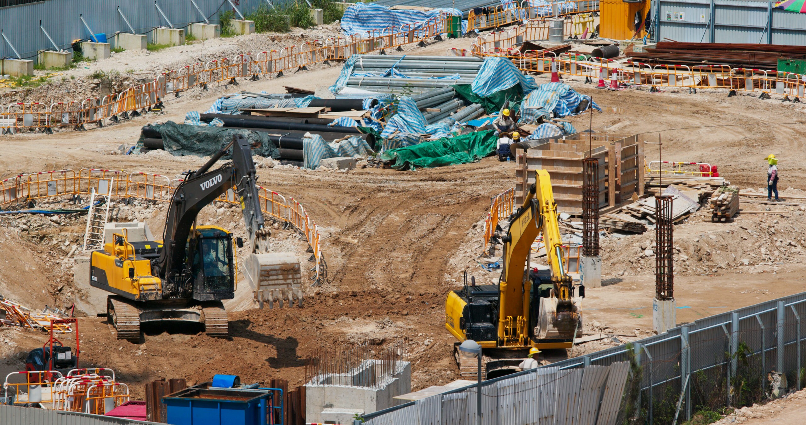 Industrial yard with heavy equipment and stored materials