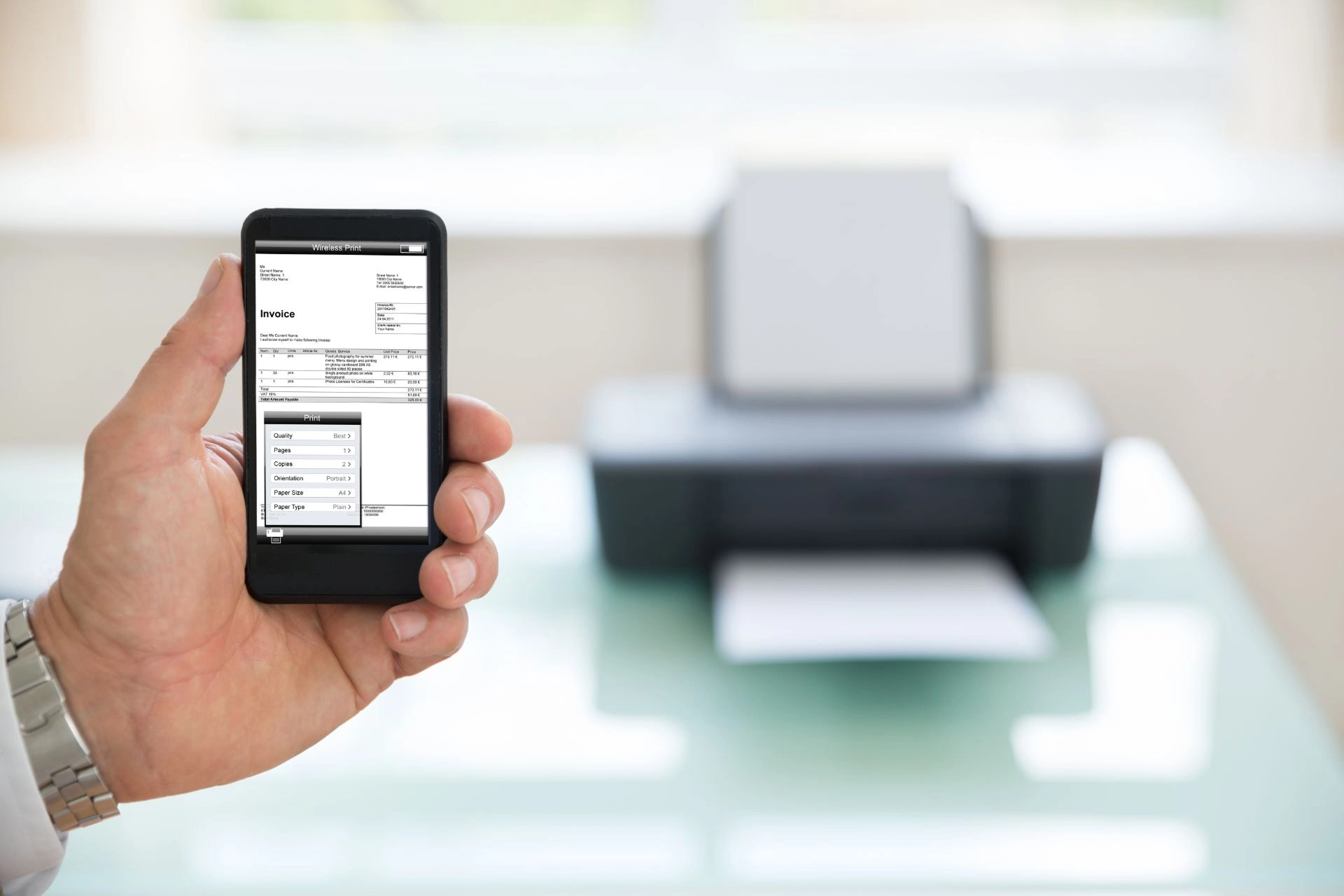 A man using a mobile phone to print invoices via a wireless printer