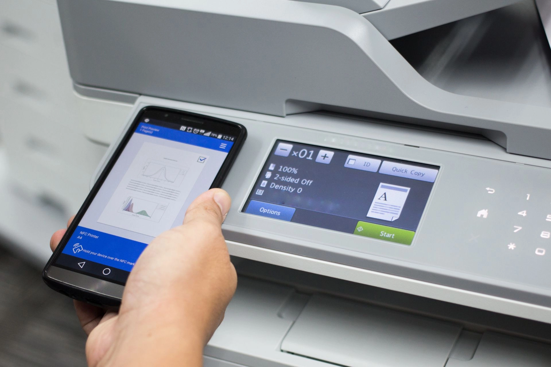 A person using his smartphone to print over Wi-Fi using a wireless photo printer