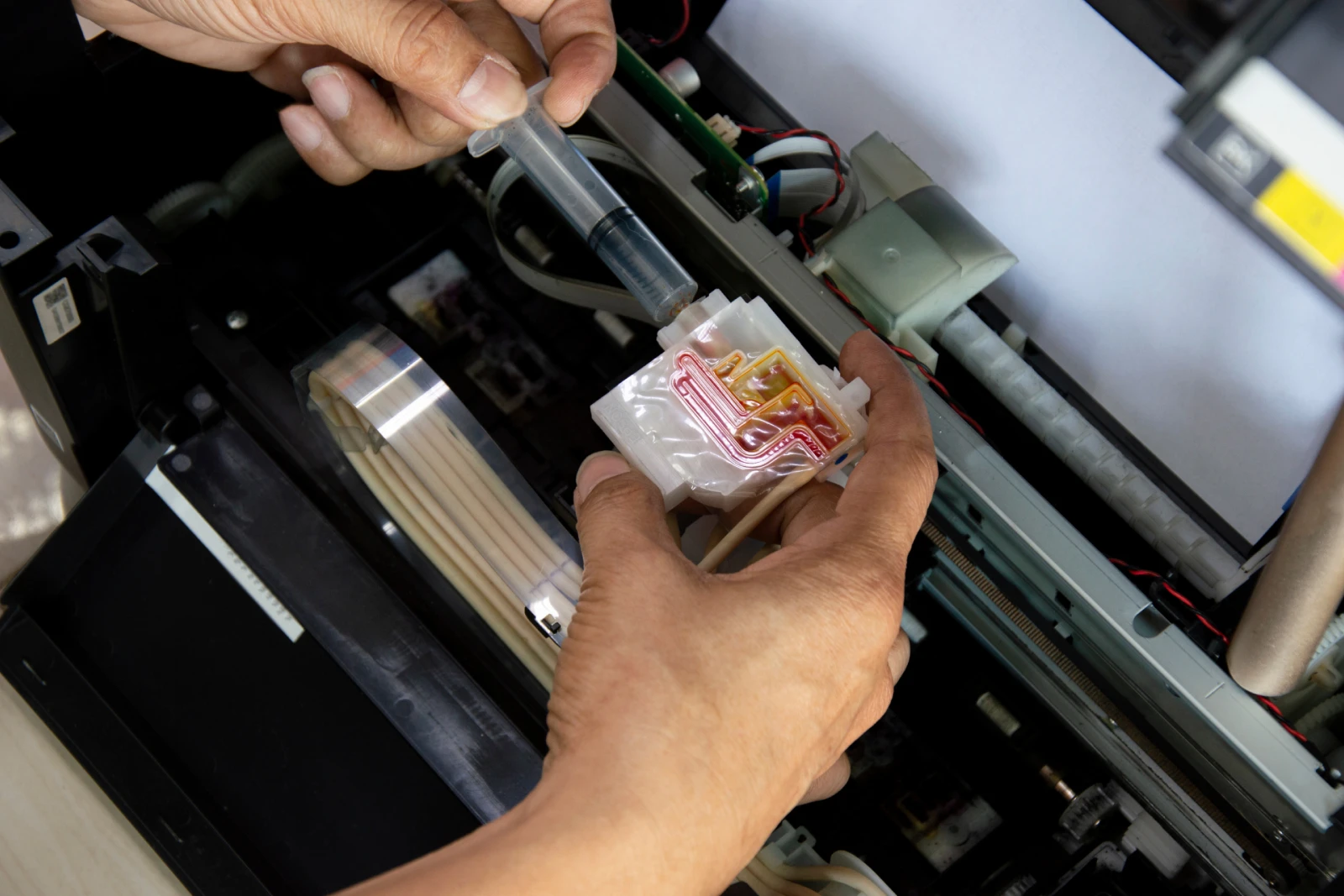 A printer technician repairing a printer