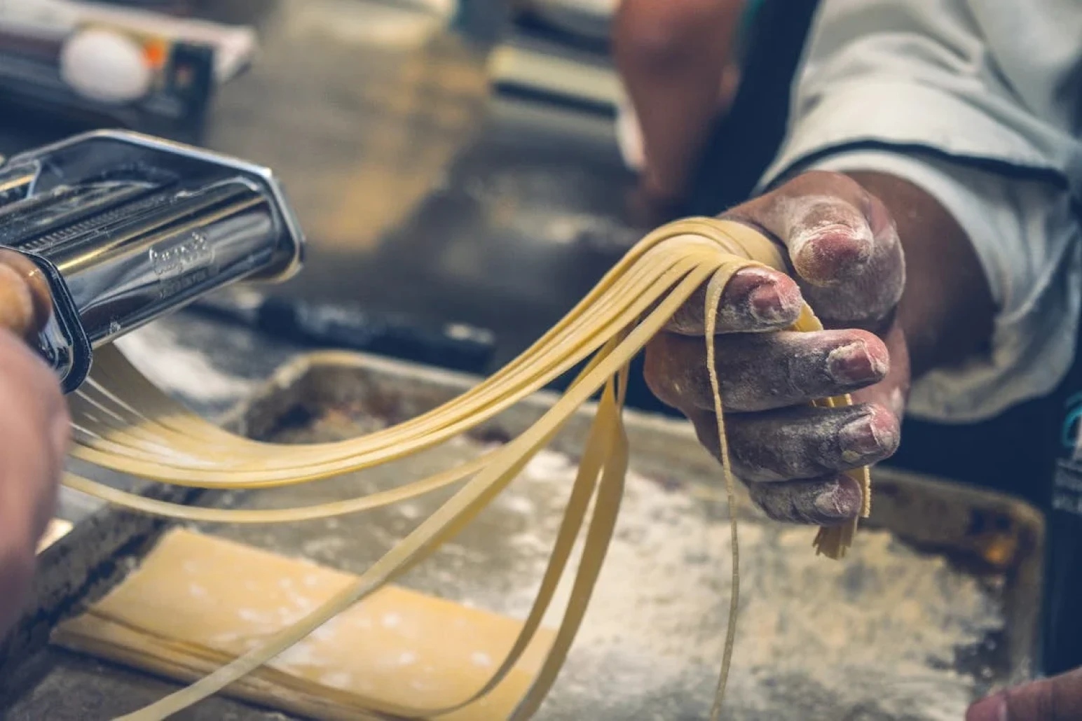 A man preparing fresh pasta from scratch