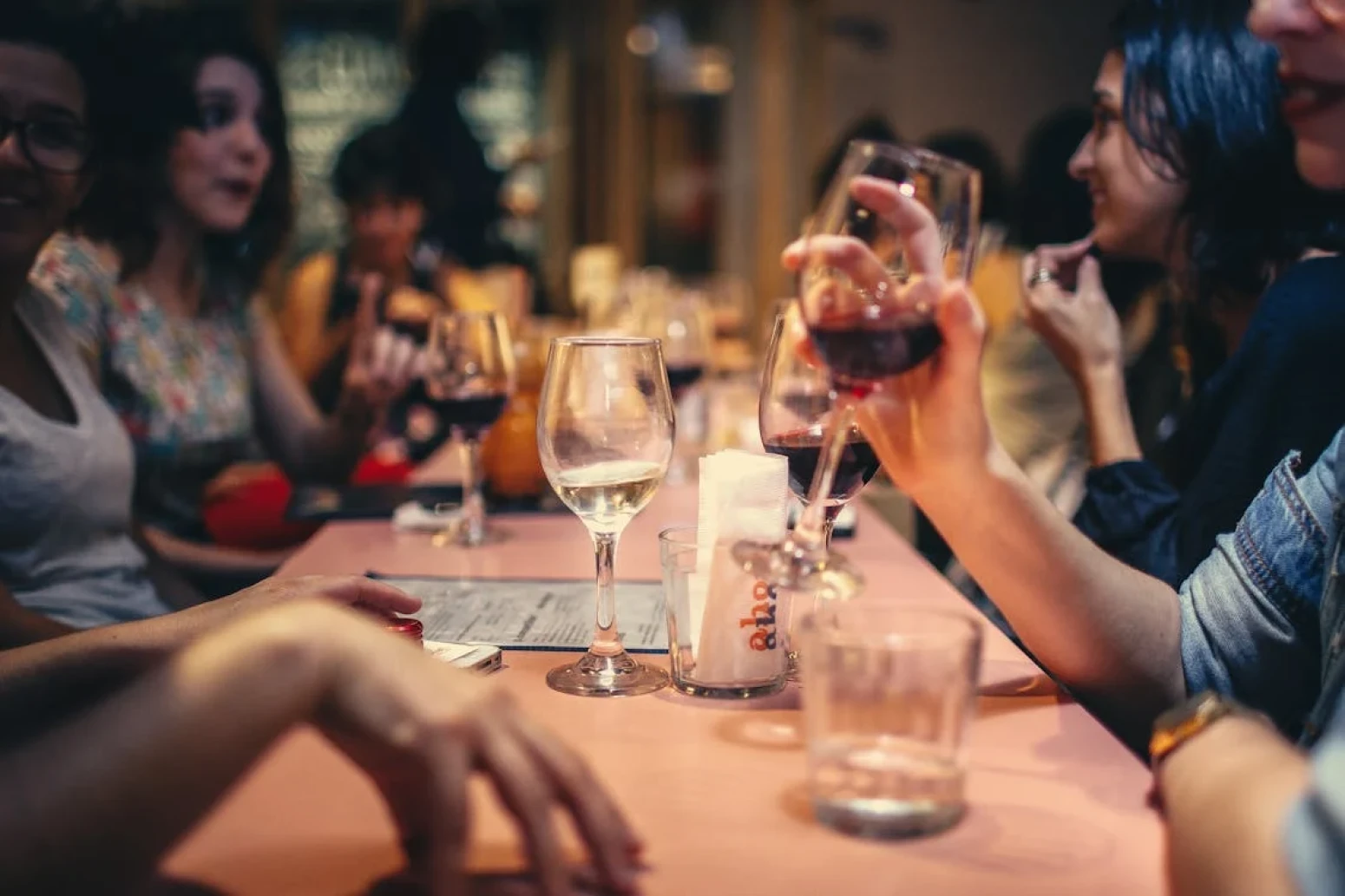 People eating and enjoying wine in a restaurant in Italy
