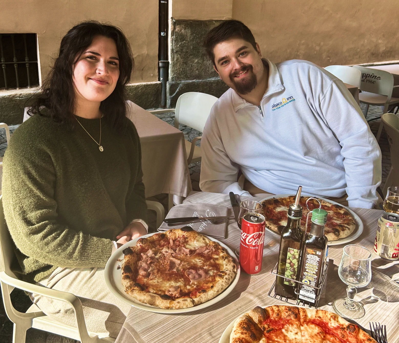 Joshua eating pizza with a friend in Turin