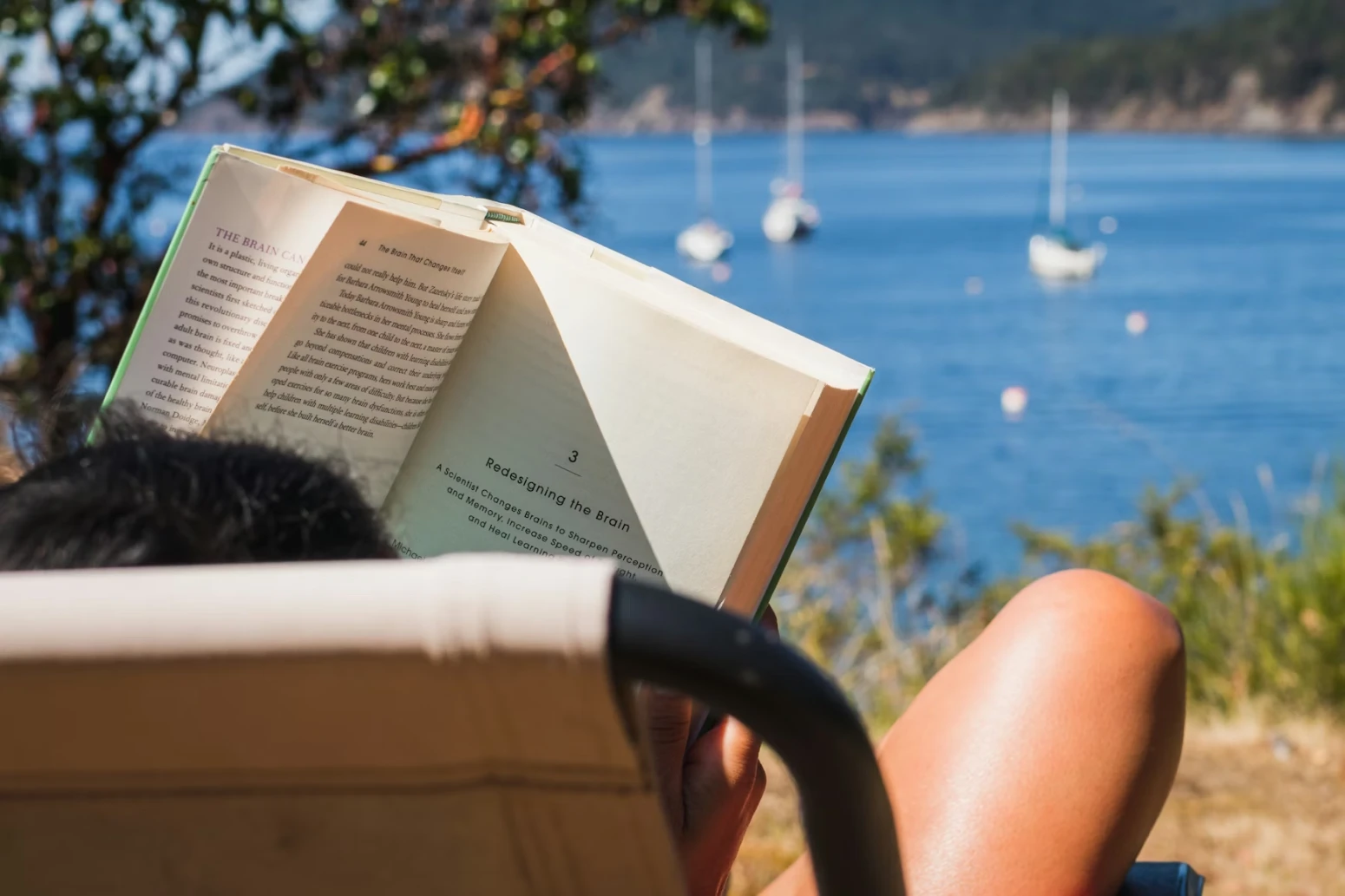 Worker reading at the seaside during a mini sabbatical
