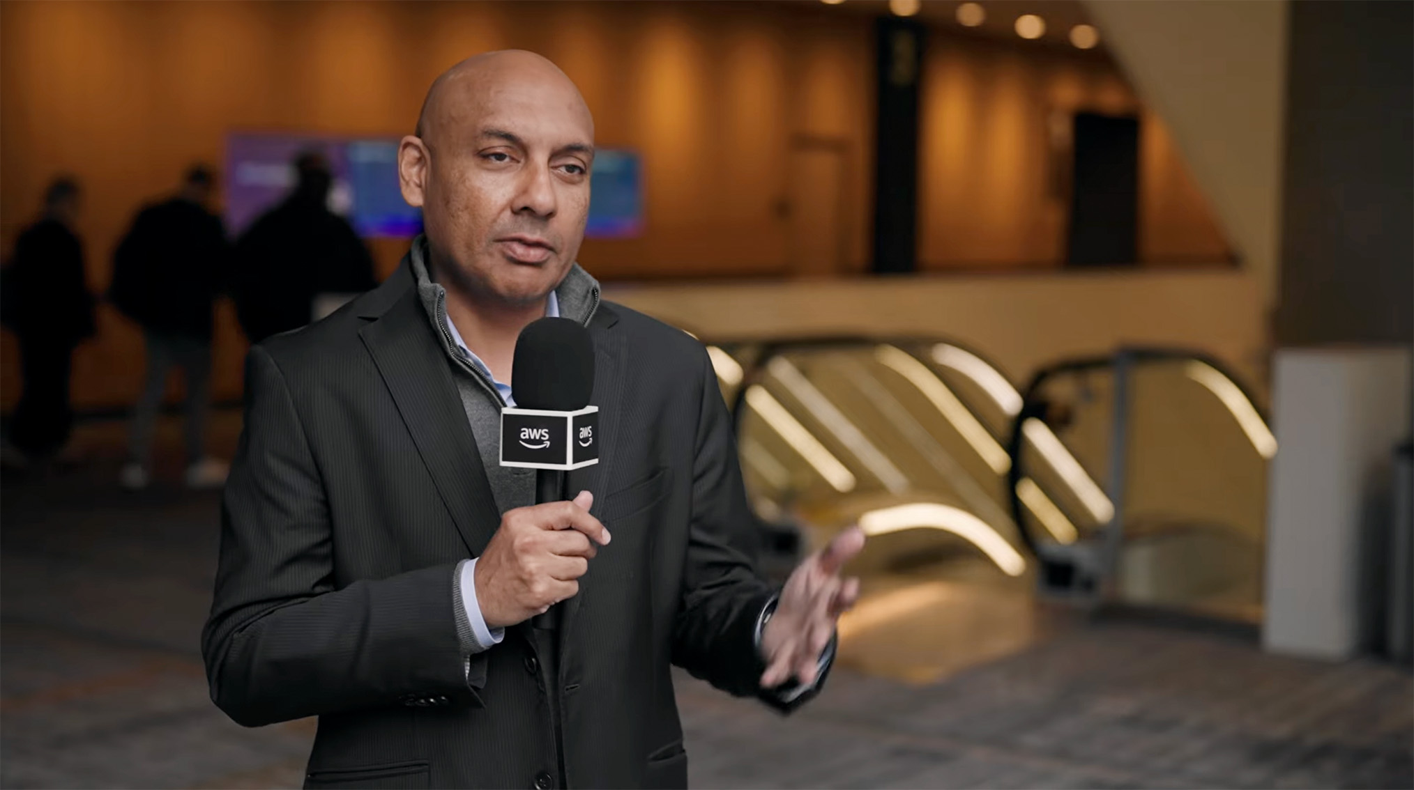Walk-up interview station at the Amazon Web Services Global Partner Summit in Seattle, featuring a branded backdrop, professional lighting setup, and attendees stepping in for on-the-spot video interviews.