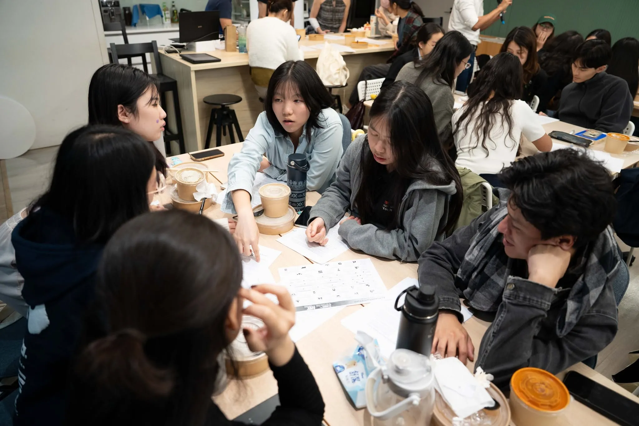 May be an image of one or more people, people studying, table and text