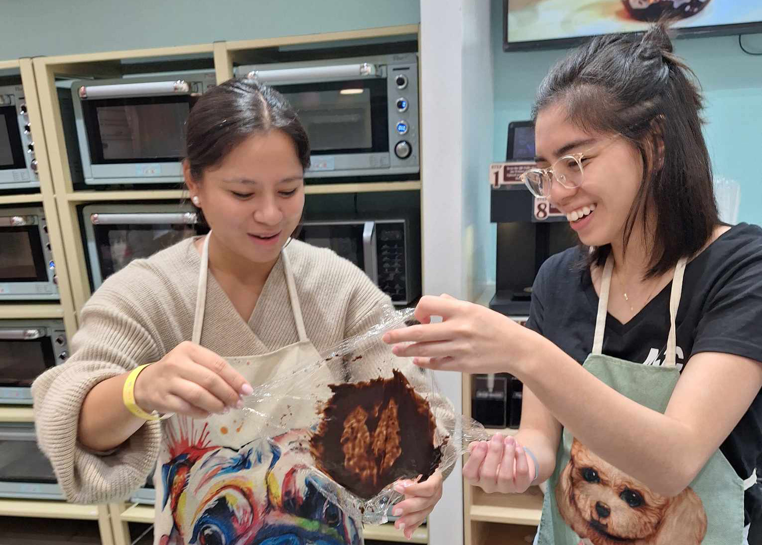 Dani and Daniella collaborating on their baking project at the Philippines team baking outing.