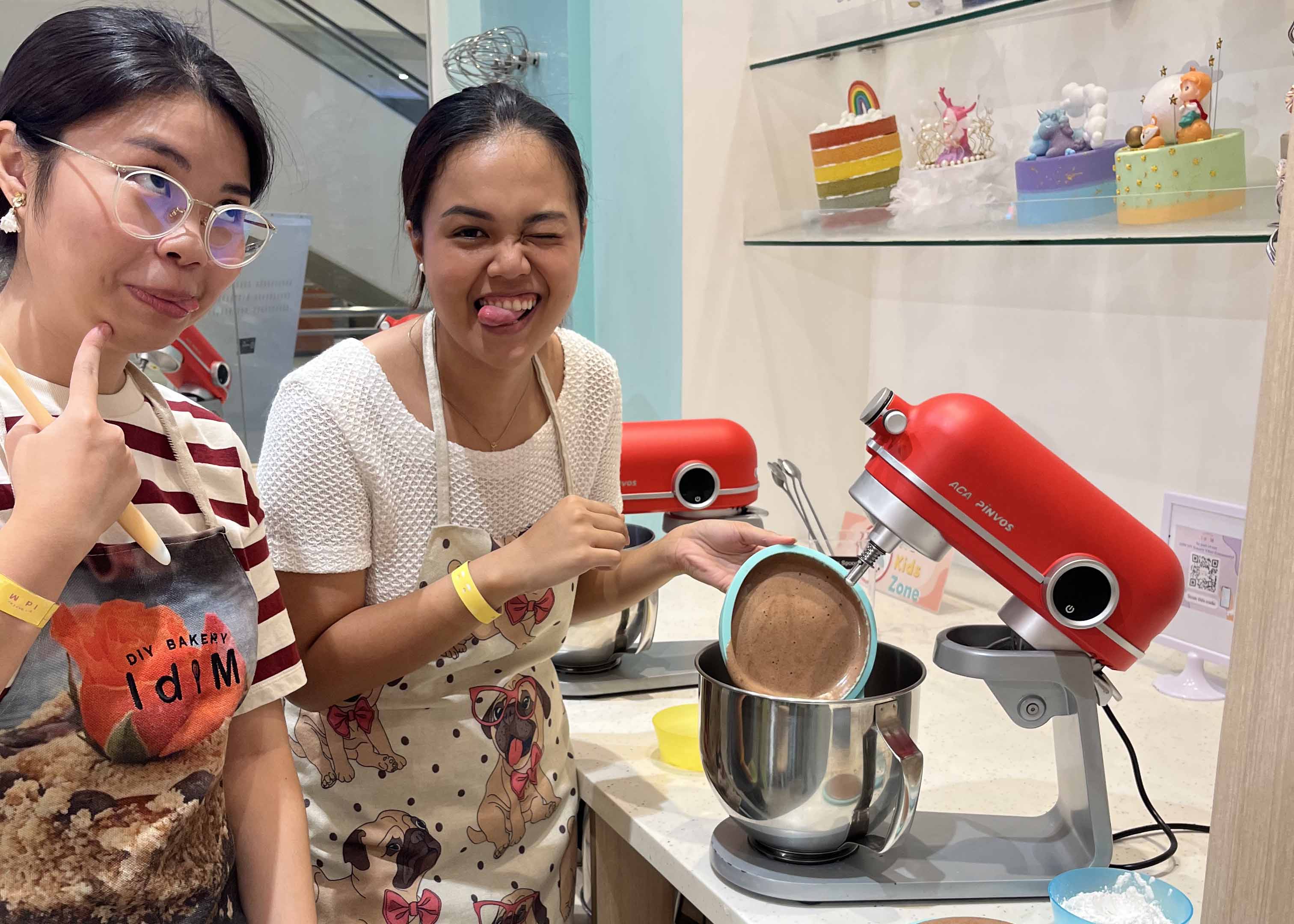 Liz and Sandra baking a cake at the Philippines' team baking outing.