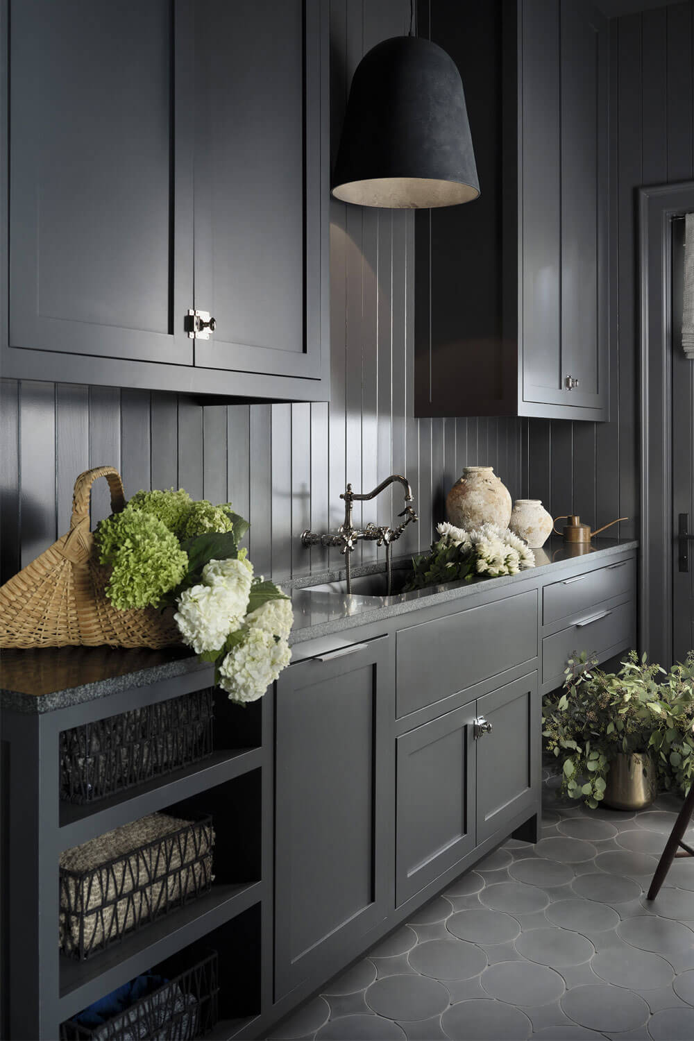 Deep charcoal custom scullery with vertical shiplap walls and furniture-grade prep cabinetry.