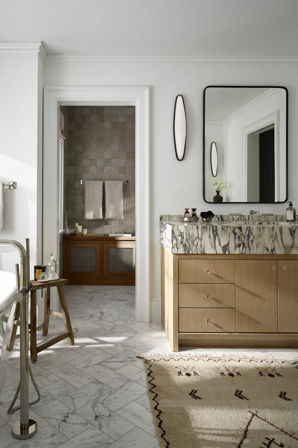 Custom wood vanity with white marble top in a modern Denver bathroom