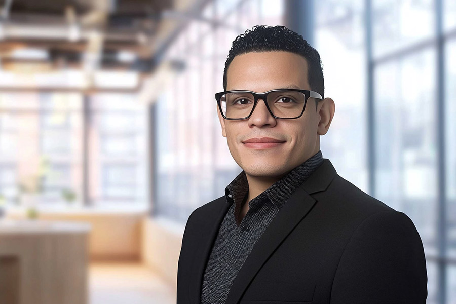 Avatar of Mario Romero in a black suit jacket and dark patterned shirt standing in a modern office with large windows and soft natural light, conveying a confident business environment.