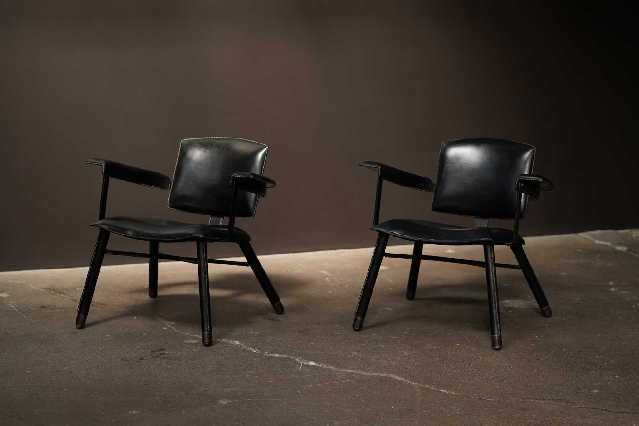 Jaques Adnet Low Arm Chairs, C1950.