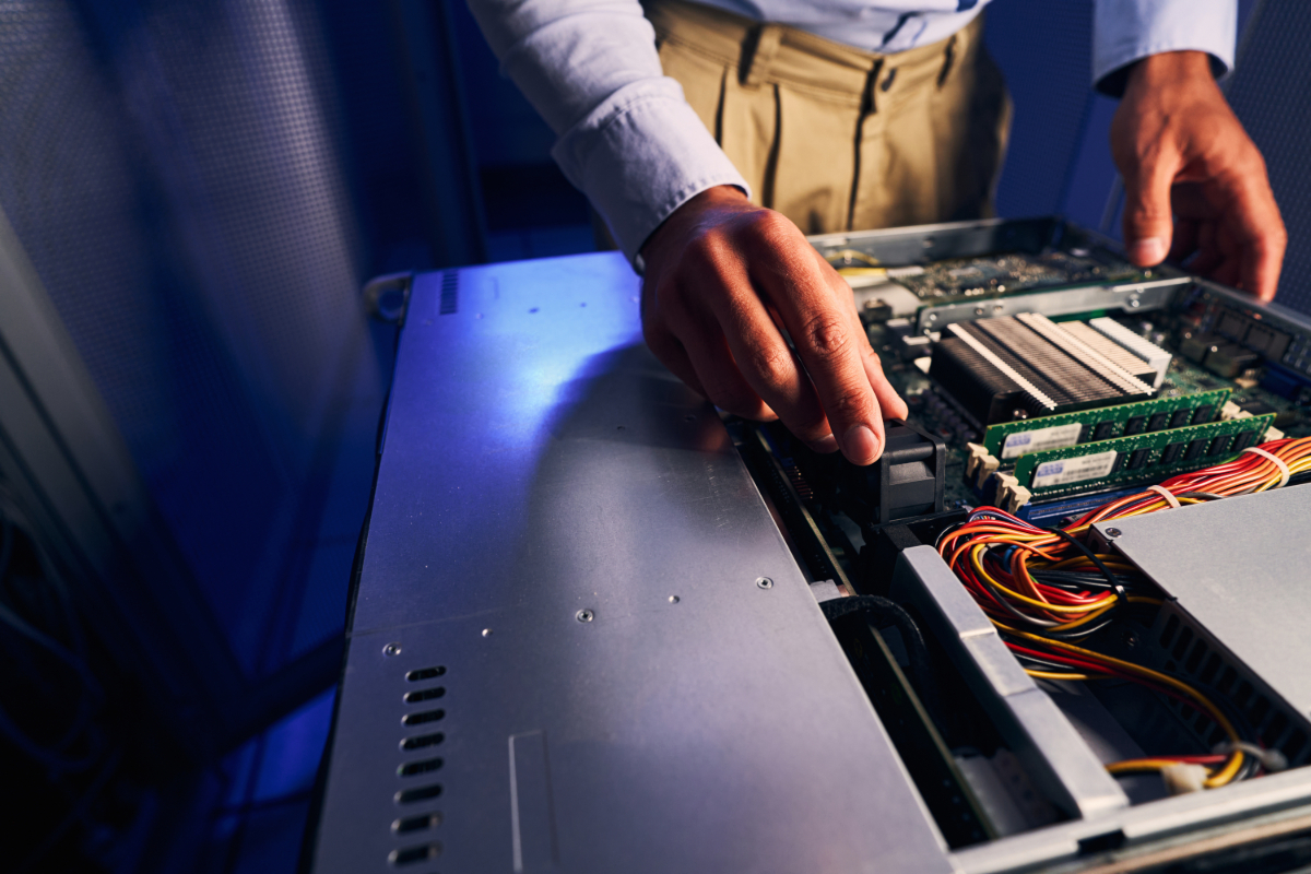 A man working on a computer with a motherboard.