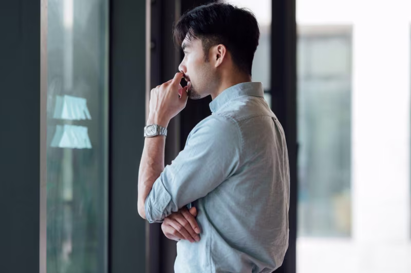 A visual depiction of a man in front of a glass door, illustrating 4 NetSuite Implementation Challenges.