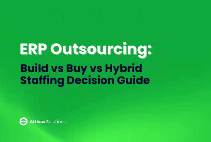 Two men in suits discuss ERP outsourcing options at a table with a laptop open between them.