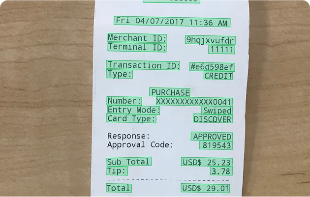 Transaction receipt dated Fri 04/07/2017 11:36 AM showing merchant ID, terminal ID, transaction ID, purchase type, card type as Discover, approval status, and payment amounts including subtotal, tip, and total of USD$29.01.