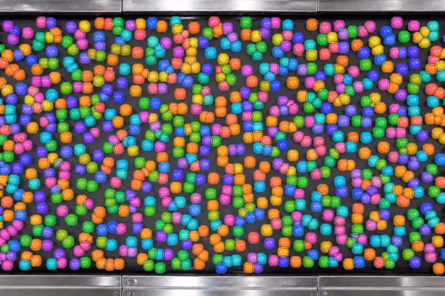 Annotations at Scale Hundreds of tiny tomato objects with valid colored instance segmentation masks on an industrial conveyor