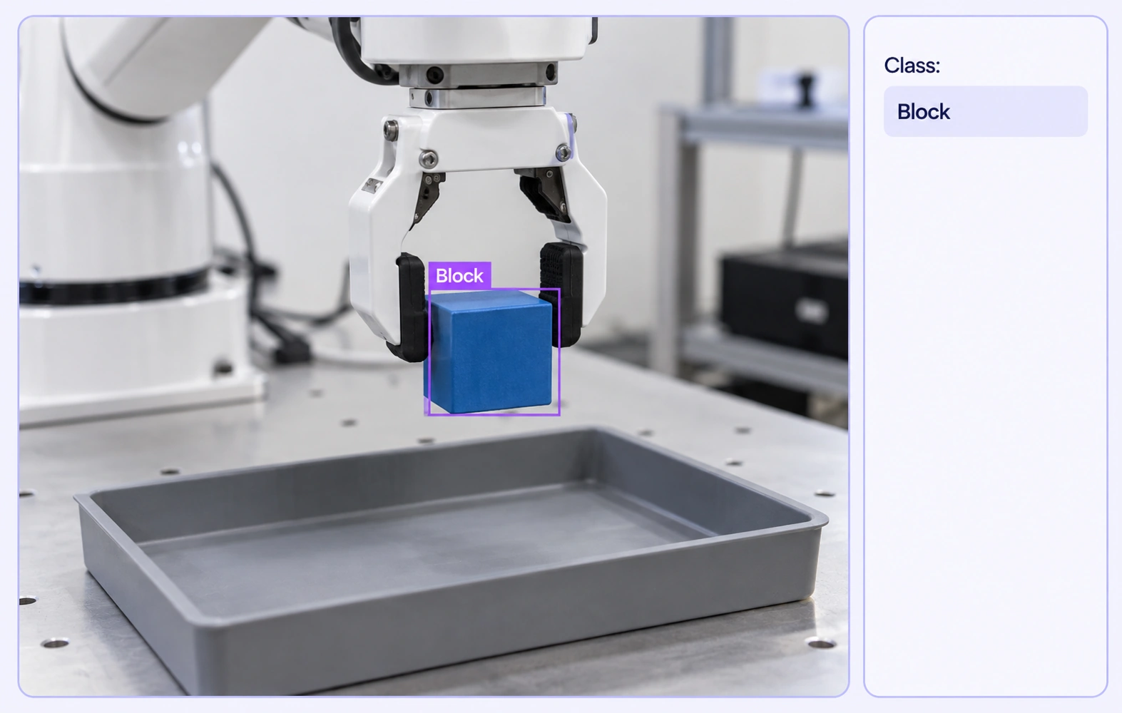 A bounding box marks a blue block in a recorded robot demonstration. A bounding box marks a blue block in a recorded robot demonstration.