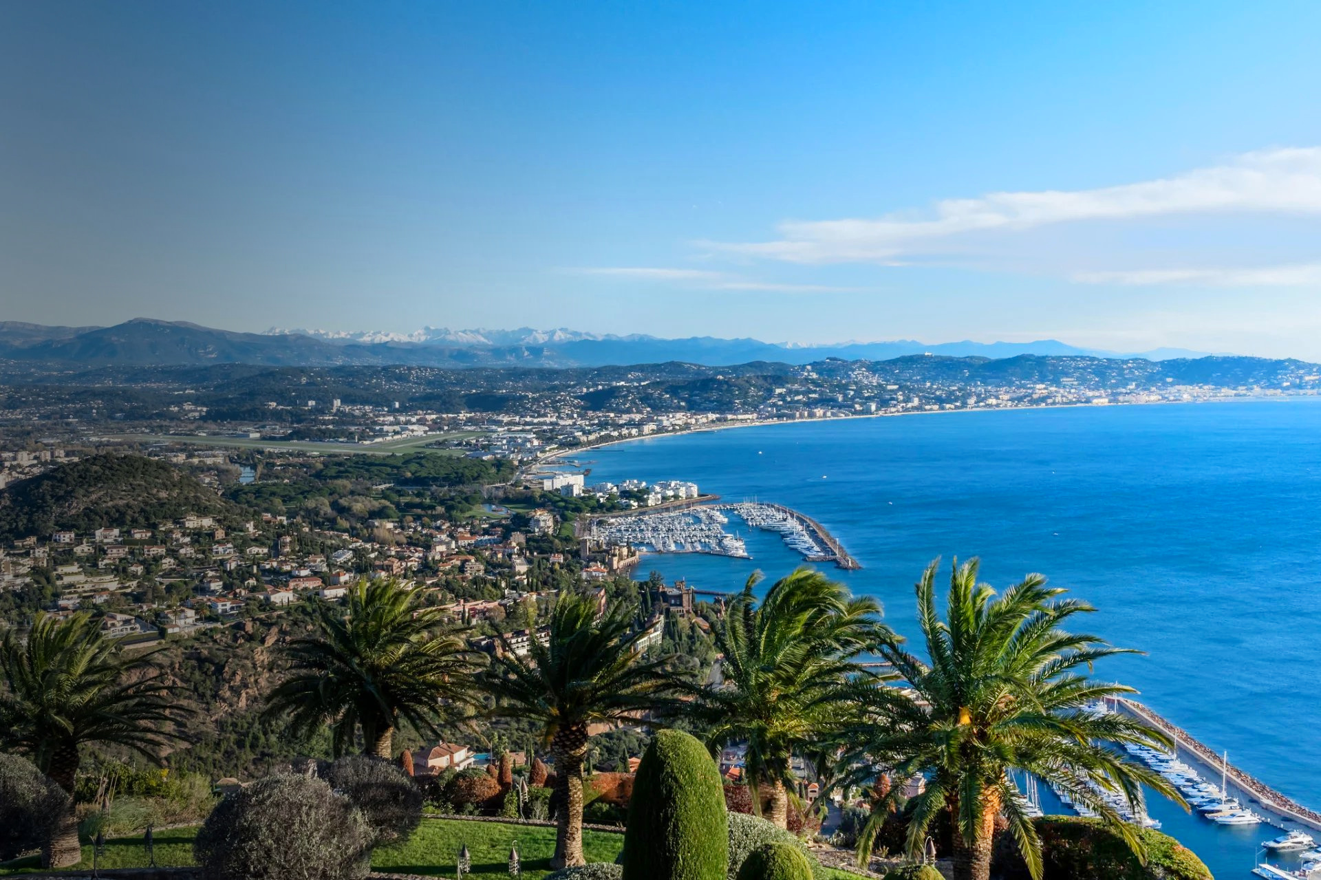 Panoramic view of the French Riviera coastline, marina and mountains