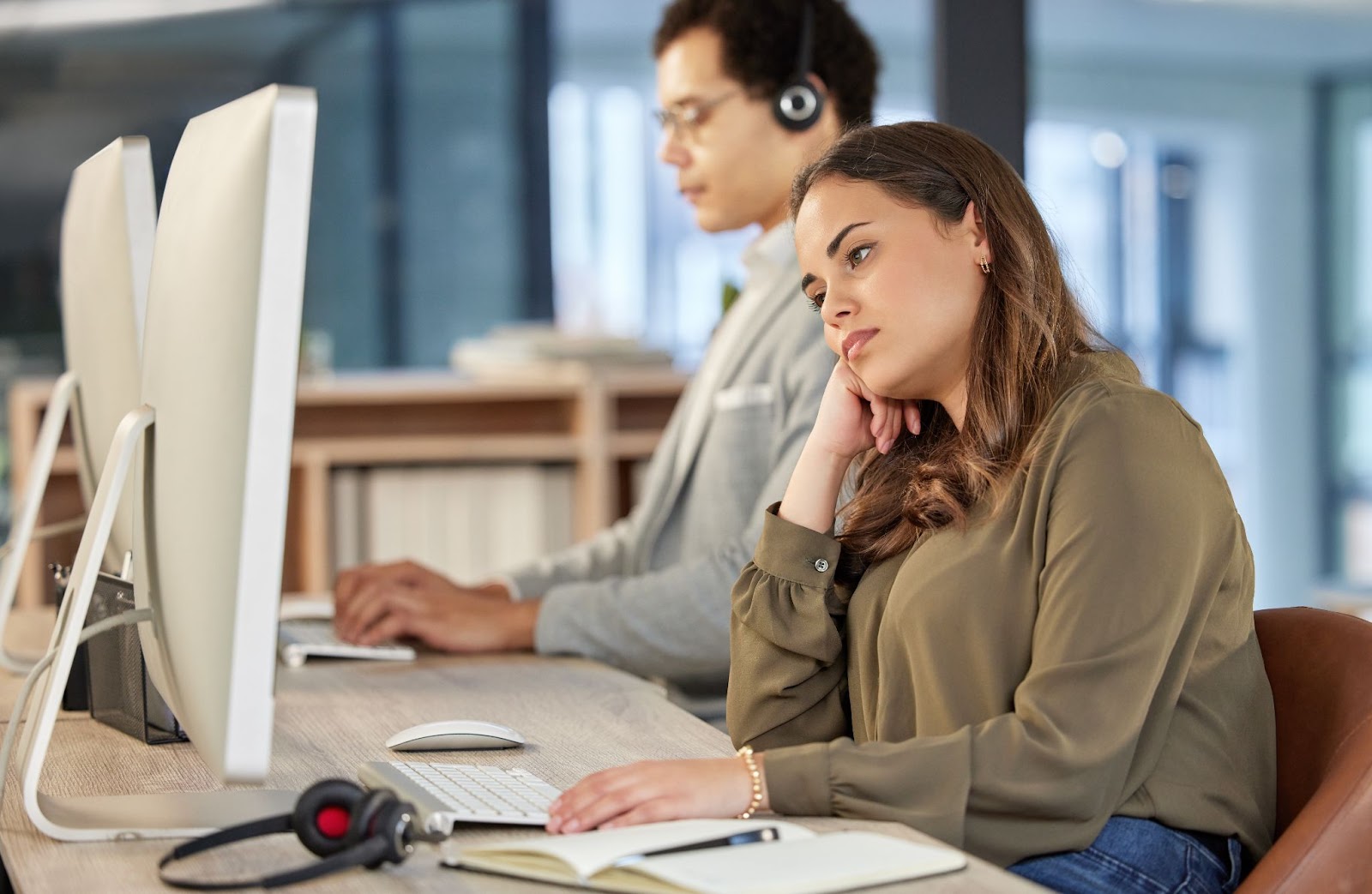 Overworked employee at their desk, highlighting presenteeism risks