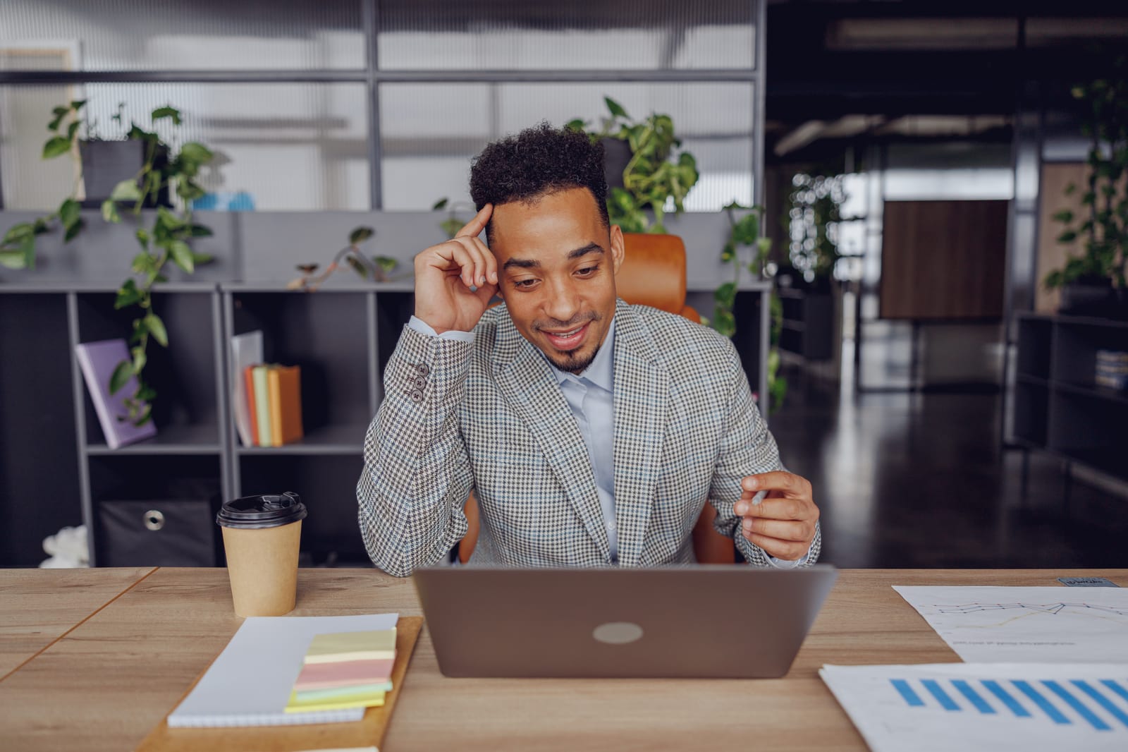 a-professional-individual-engaged-in-work-at-a-laptop-within-a-contemporary-office-setting