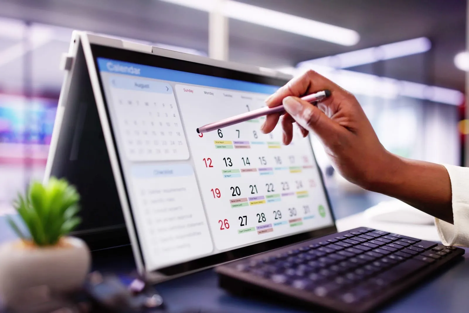 A businesswoman organizing calendar appointments and meetings on laptop