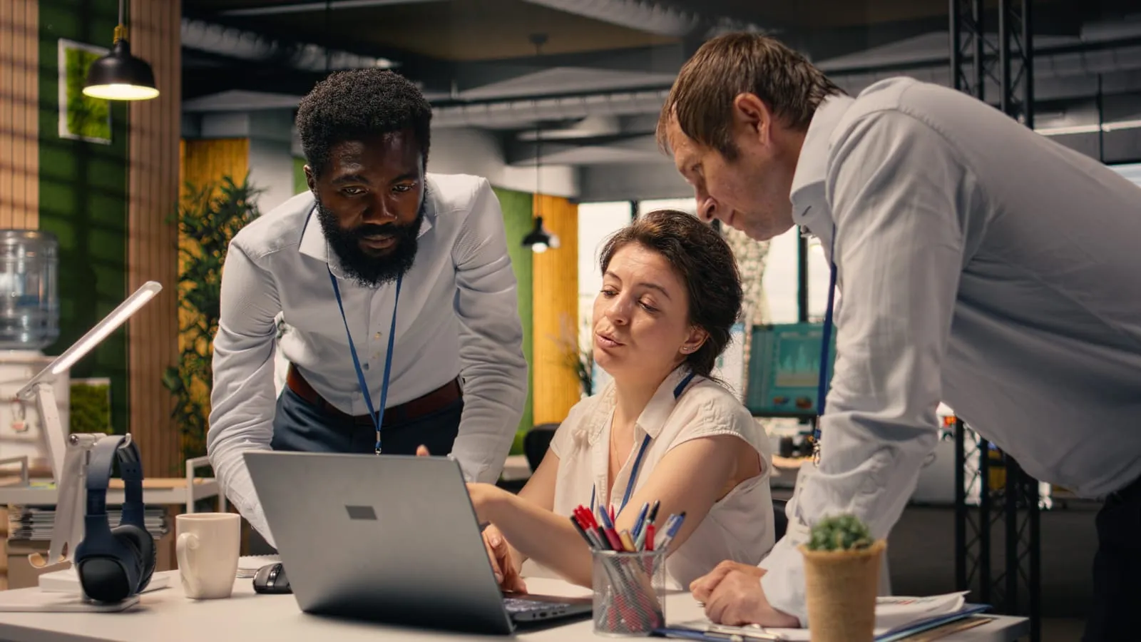 Business professionals collaborating and reviewing information on a laptop screen