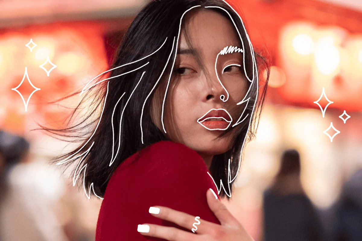 A woman with dark hair wears a red top with a thoughtful expression. White line art accents her features, set against a blurred, warm-toned background.