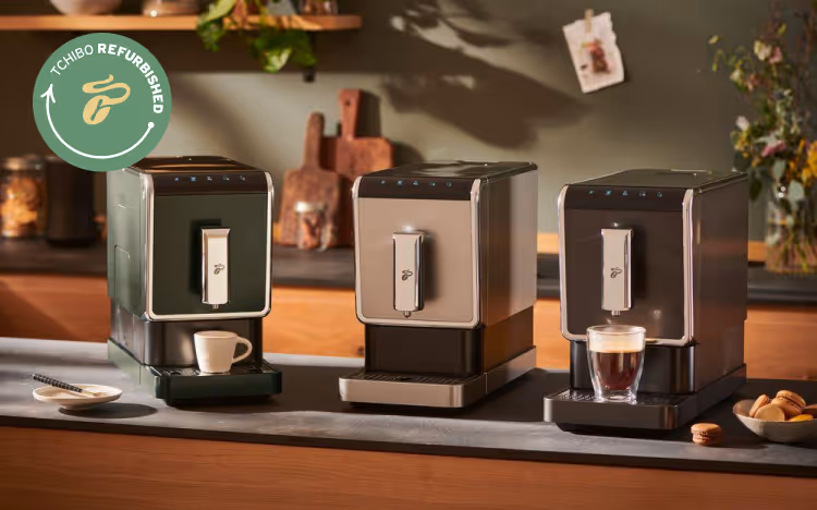 Three Refurbished Tchibo Esperto Caffè coffee makers on a sideboard.