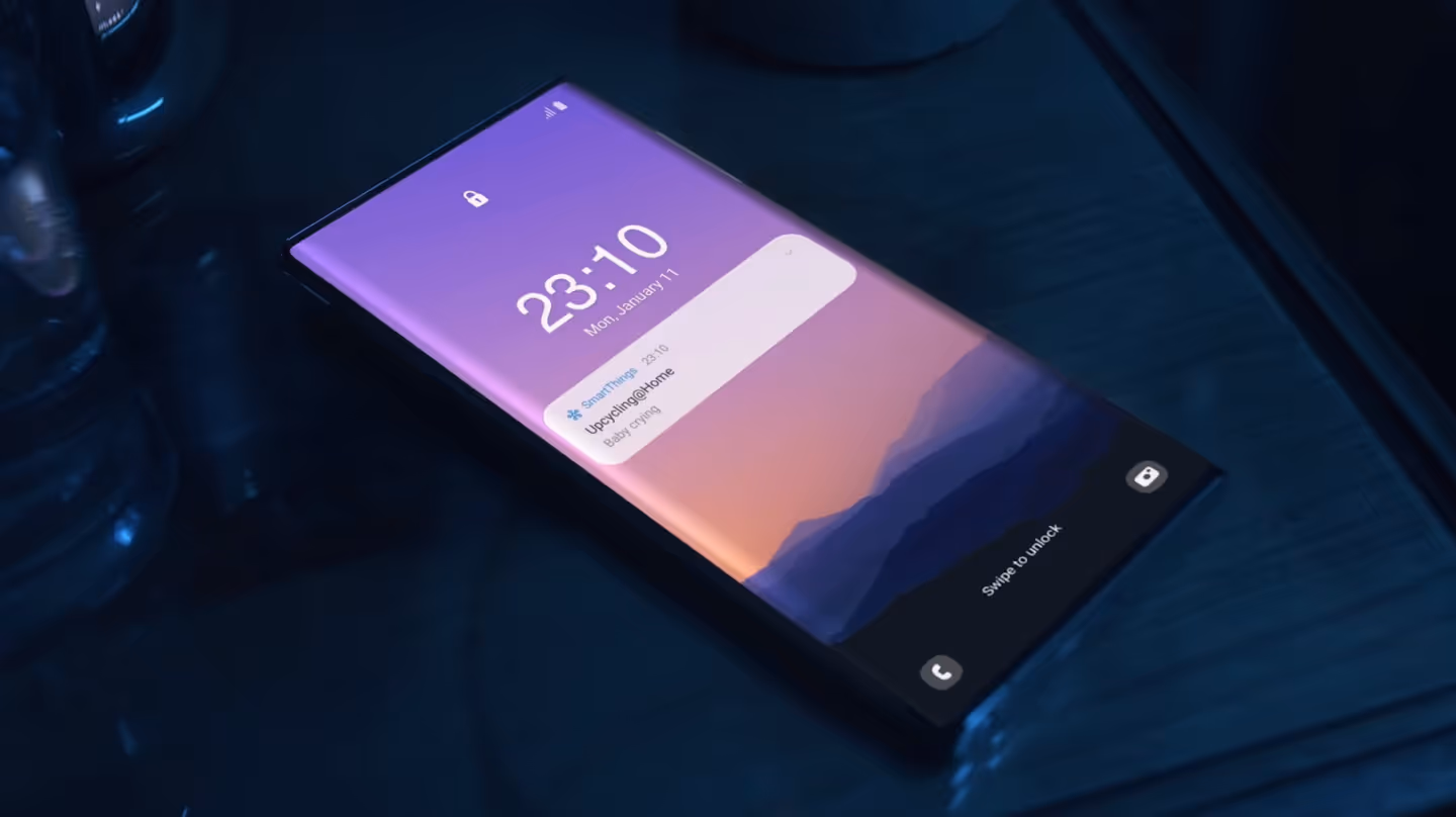 A sleek smartphone lying on a dark table at night, showing a lock screen notification from SmartThings with the title “Upcycling@Home – Baby crying.”