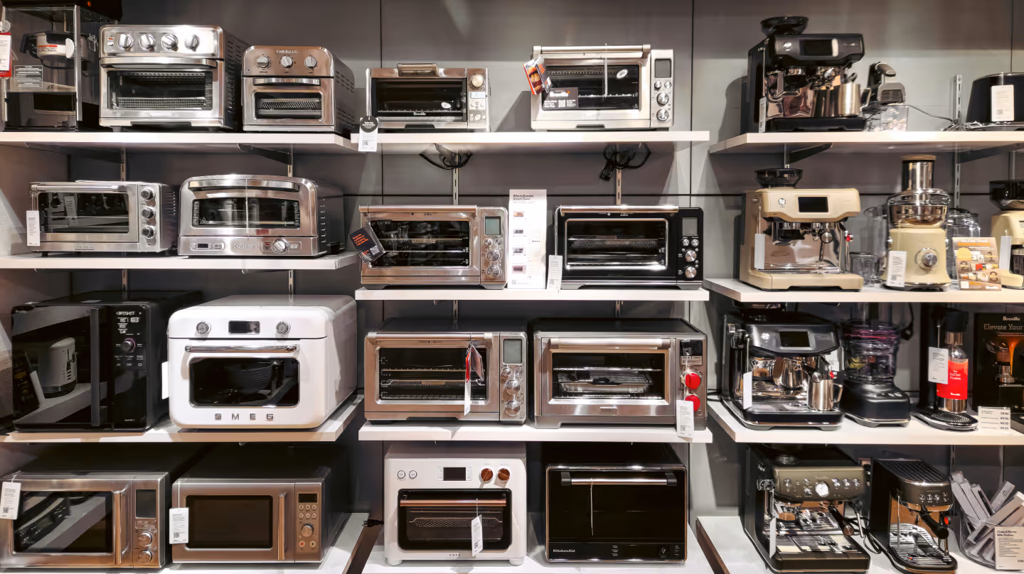 Display of small kitchen appliances such as mini ovens, coffee machines, and microwaves – symbolizing the wide range of devices that will soon feature digital product passports for sustainability and compliance.