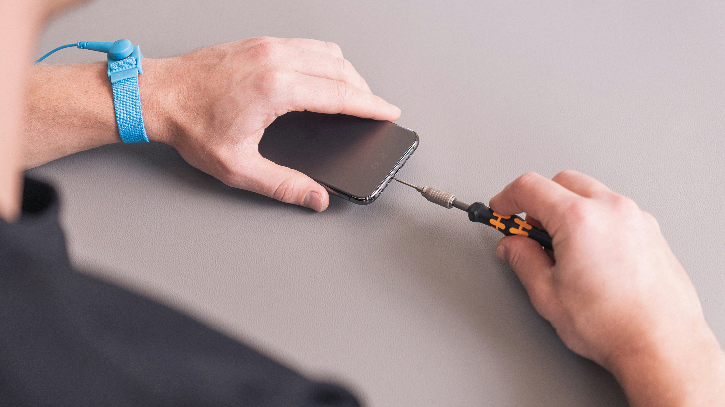 A smartphone is being repaired.