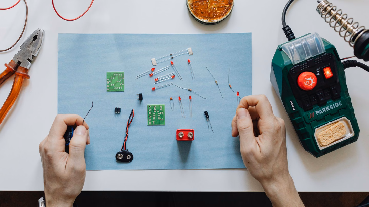 Parkside soldering station beside hands assembling a DIY LED circuit board