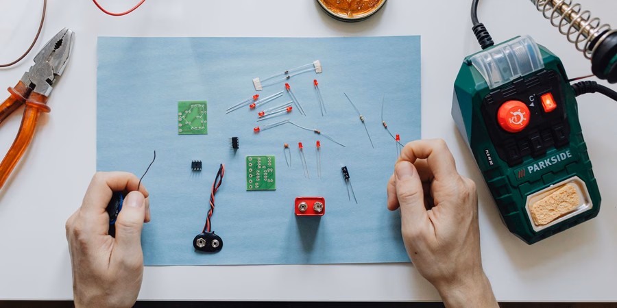 Parkside soldering station beside hands assembling a DIY LED circuit board