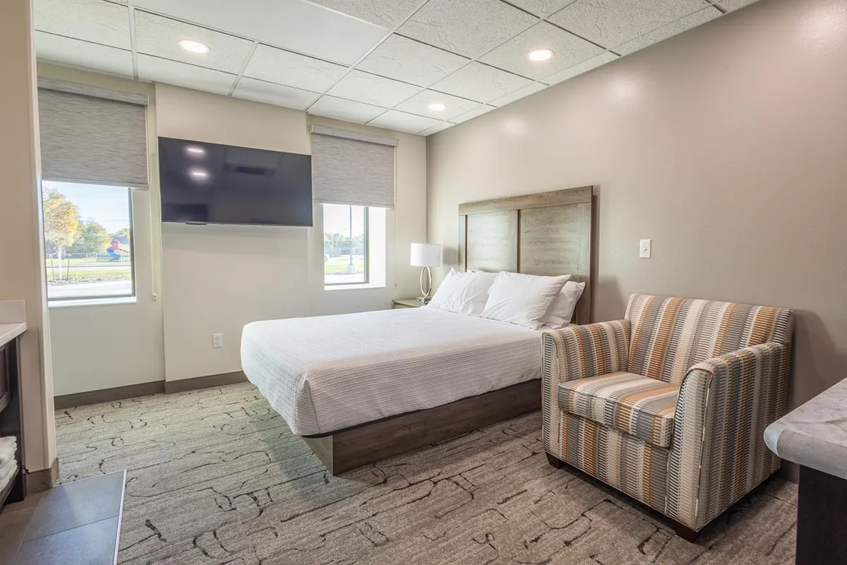 queen bedroom with chair