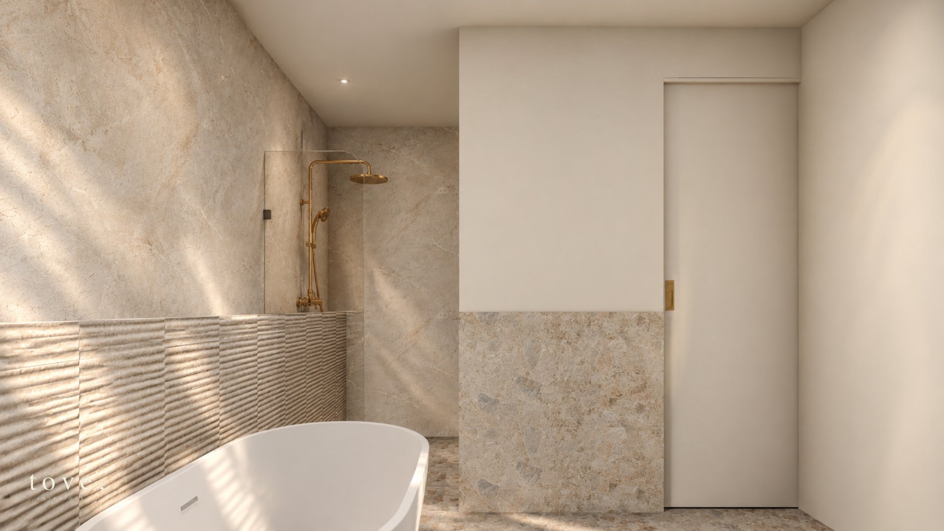 Fremantle ensuite with brushed brass shower and stone walls