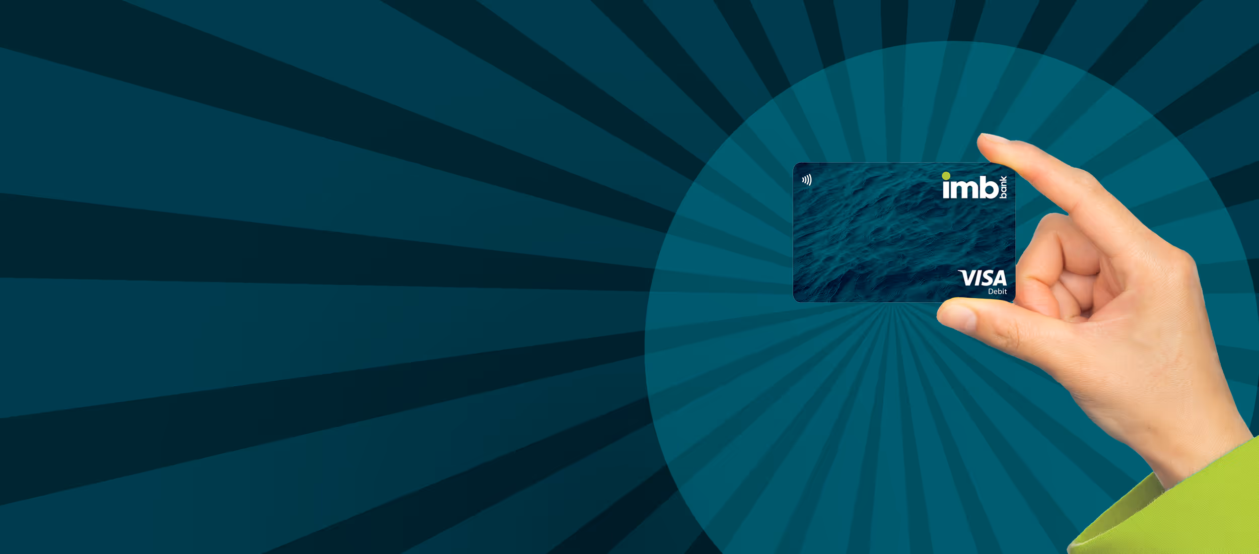 Hand holding an imb bank Visa Debit card with a water pattern background and dark blue radial rays.