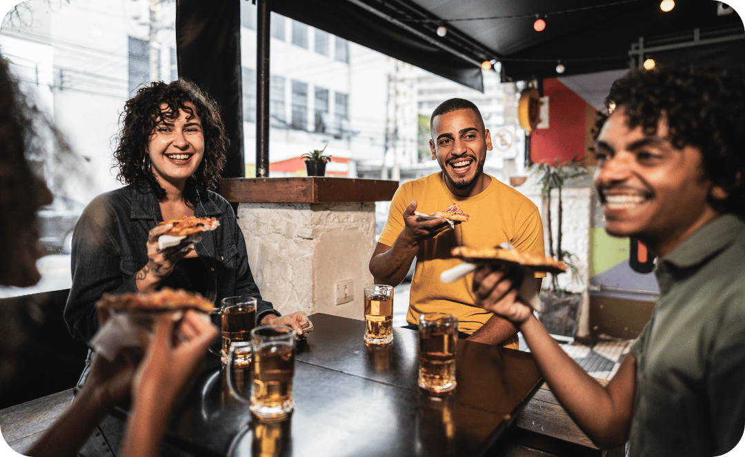 friends eating pizza with beer