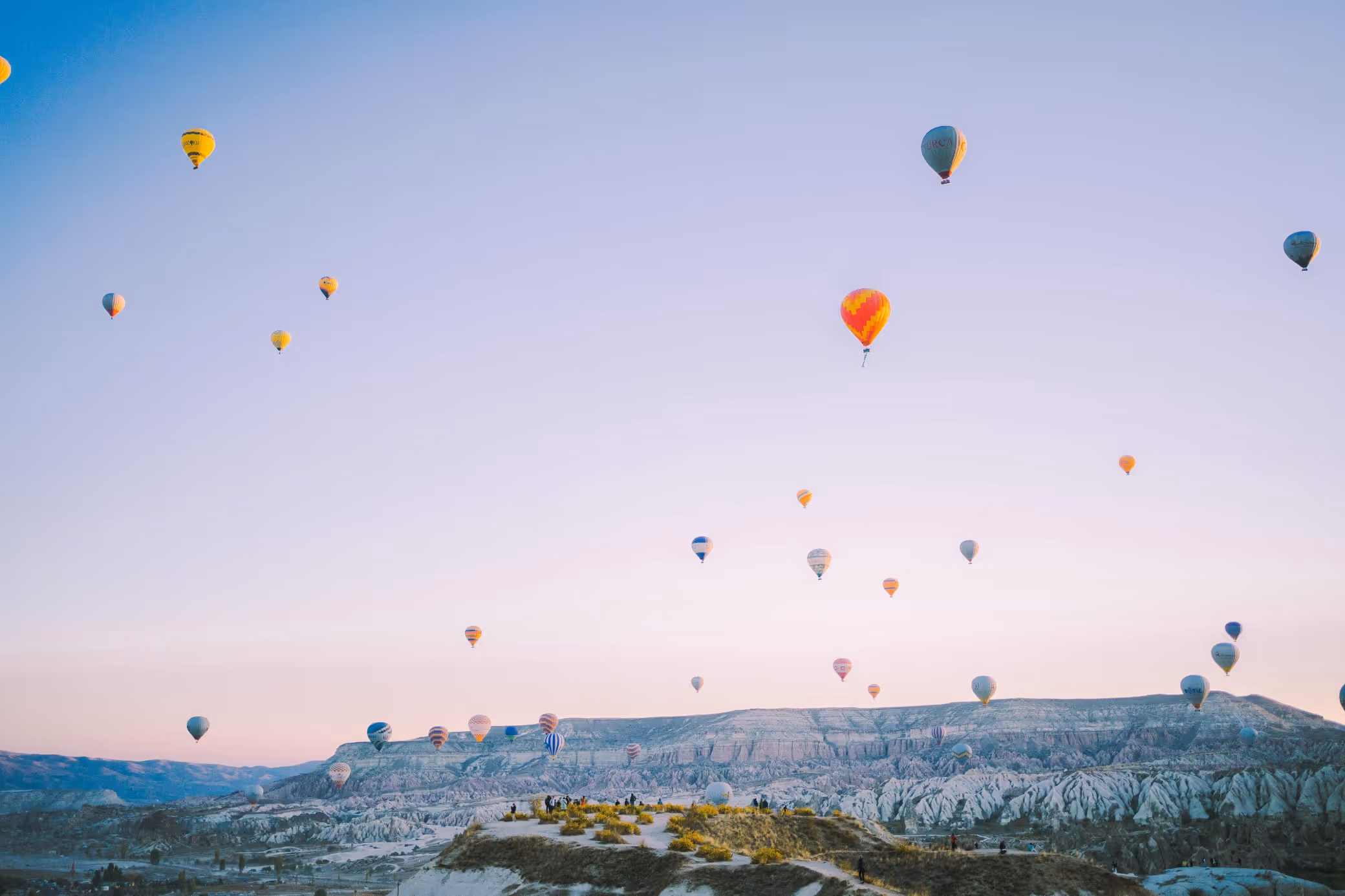 hot air balloons in the sky over mountains