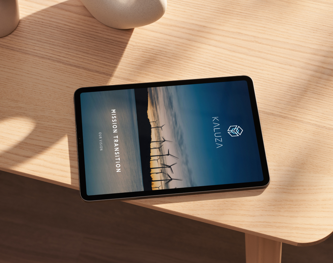 ipad on a wooden table showing kaluza cover page
